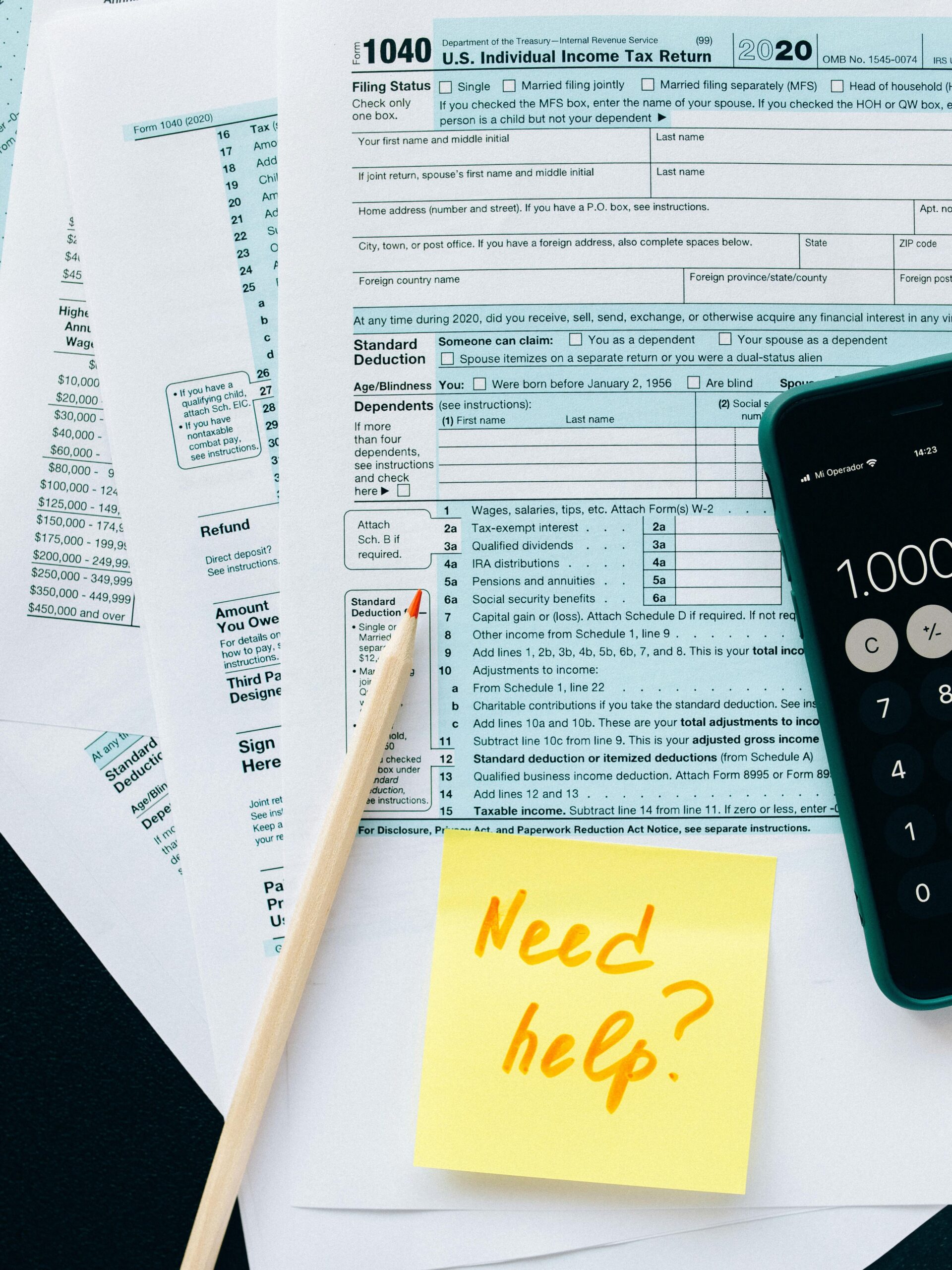 Close-up of tax forms with a calculator and a note asking for assistance.